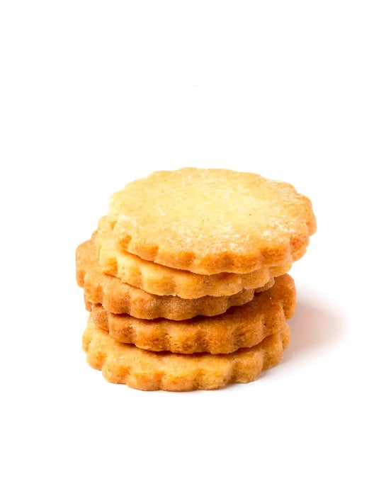 A stack of shortbread biscuits featuring a scalloped edge.