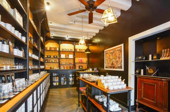 The interior of a shop featuring a central table surrounded by shelves filled with elegant packaging.