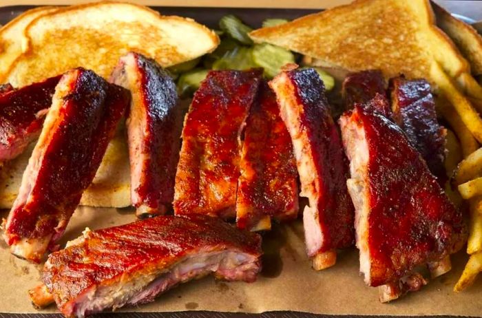 A serving of Joe's Kansas City Bar-B-Que, renowned for its brisket, burnt ends, and ribs.