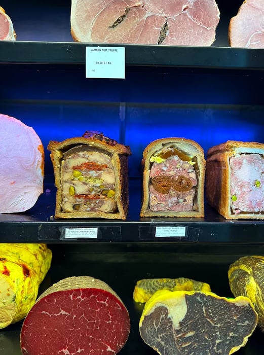 Shelves lined with terrines and cured meats.