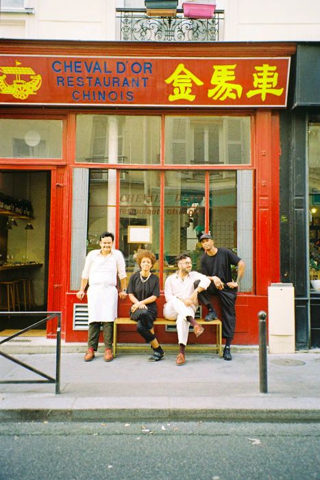 Four diners gather in front of Le Cheval d’Or restaurant.