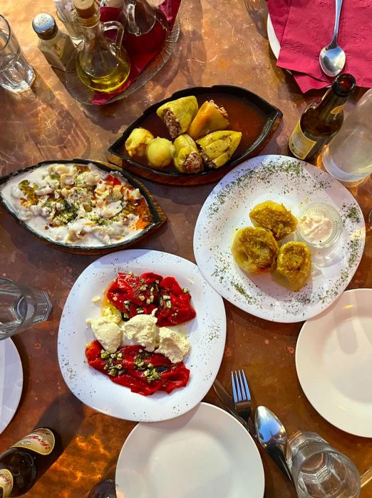 An array of Balkan dishes featuring peppers, dumplings, and a savory casserole.