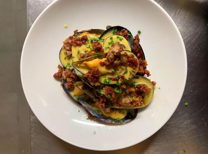 A bird's-eye view of shellfish adorned with various toppings.