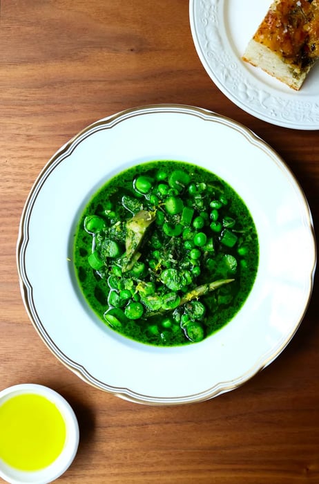 A rich and vibrant stew brimming with spring vegetables.