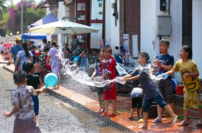 Boys douse each other with water to celebrate Pi Mai (Lao New Year) in Luang Prabang, Laos.