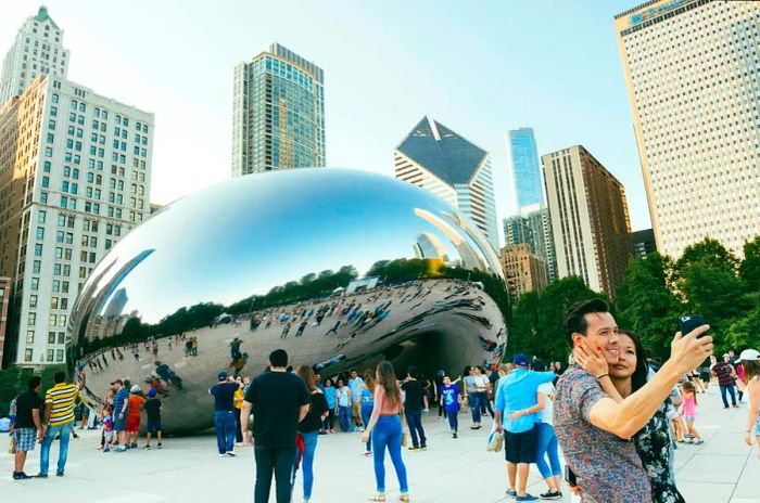 Visitors gather around the iconic Cloud Gate sculpture in Millennium Park.