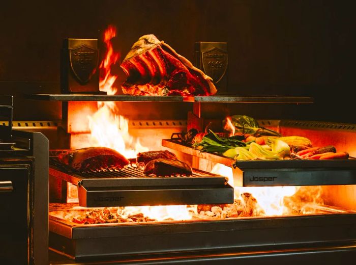 A dual grill where meats and vegetables sizzle over an intense flame.