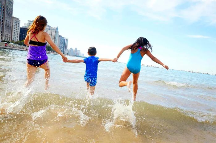 Children running joyfully along the beach in Chicago