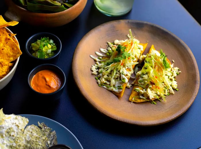 A close-up view of tostadas topped with various ingredients.