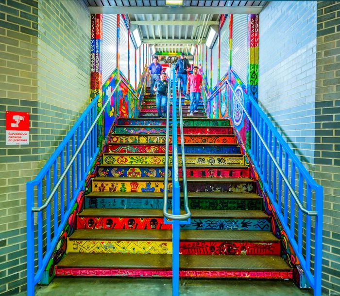 Colorful street art adorns the steps leading out of a metro station