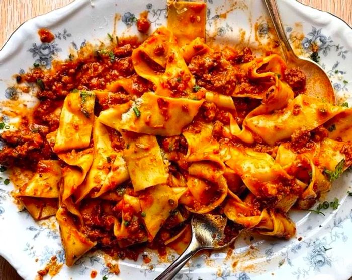 A beautifully plated serving of meat-sauced pappardelle