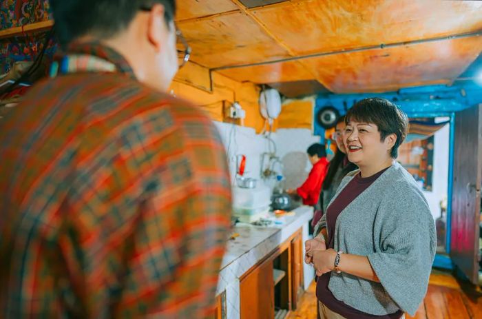 A traveler converses with a Bhutanese local during a homestay experience in Bhutan