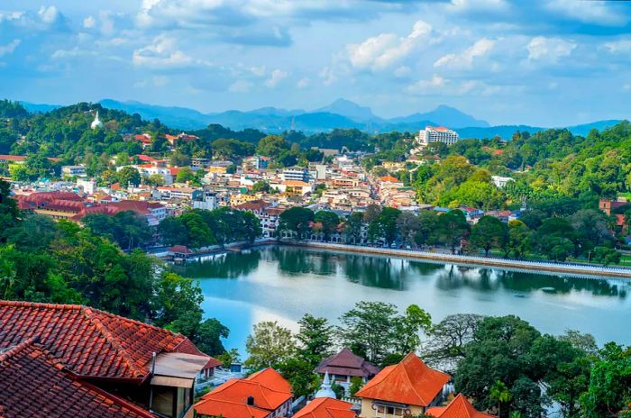 A scenic view over Kandy's lake, featuring temples in the foreground.