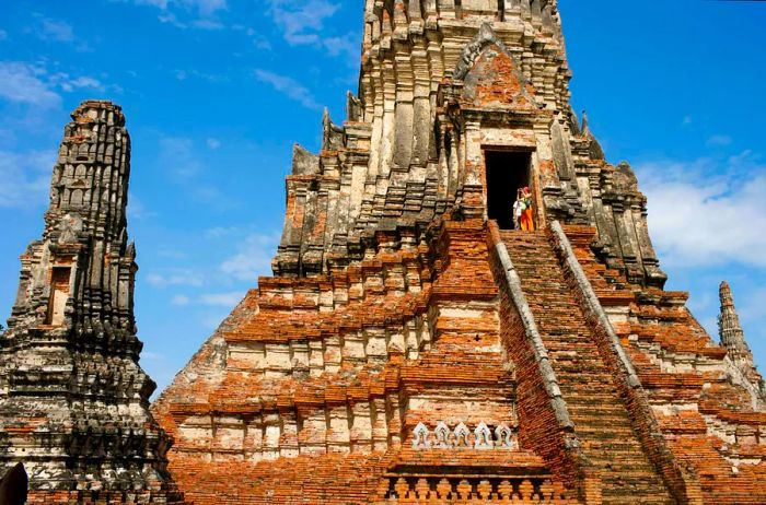 Visitors ascend the steps to Wat Chaiwattanaram in Ayutthaya, Thailand.