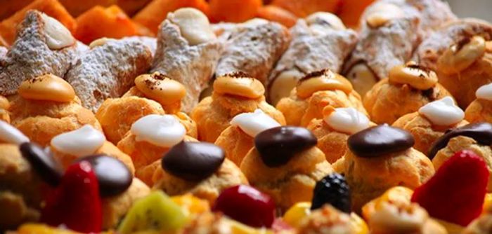 An array of colorful pastries arranged neatly in display cases.