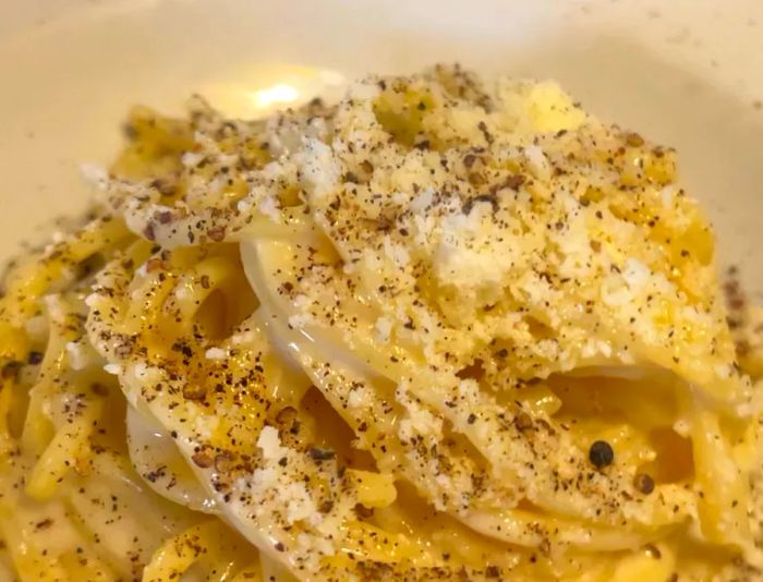 A bowl filled with cacio e pepe pasta.