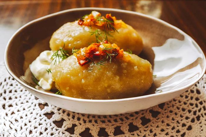 A traditional Lithuanian specialty, cepelinai are potato dumplings filled with minced meat, cheese, or mushrooms. These dumplings are crafted from both grated and riced potatoes.