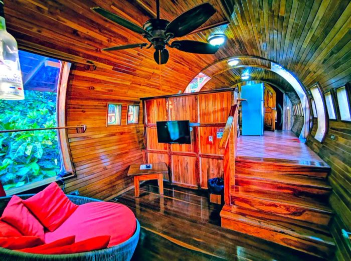 A teak-lined room at 727 Fuselage Home, located inside a decommissioned passenger plane.