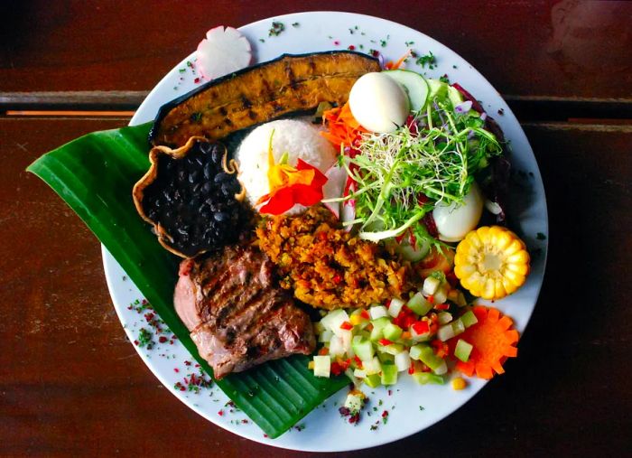 A serving of casado, which is a traditional Costa Rican meal consisting of rice, beans, plantains, and meat.