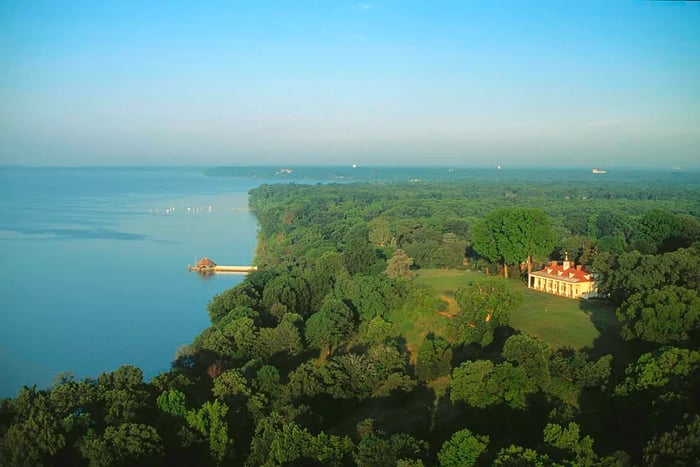 An aerial view of George Washington’s estate, Mount Vernon, surrounded by woods and the Potomac River