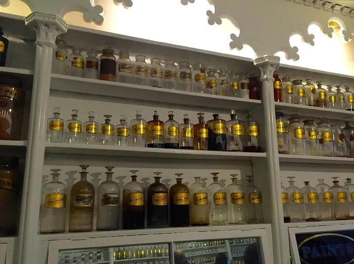 Shelves filled with glass bottles at the Stabler-Leadbeater Apothecary Museum.