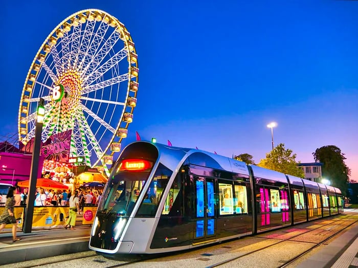 A glimpse of Schueberfouer, Luxembourg's annual traditional fair, with a tram passing by.