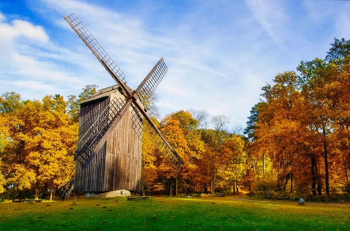 An ancient wooden windmill at the Estonian Open Air Museum, captured during the fall. A historical landmark of Estonia.