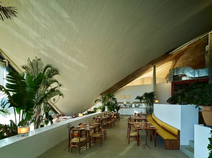 A dining space featuring an impressive curved ceiling.