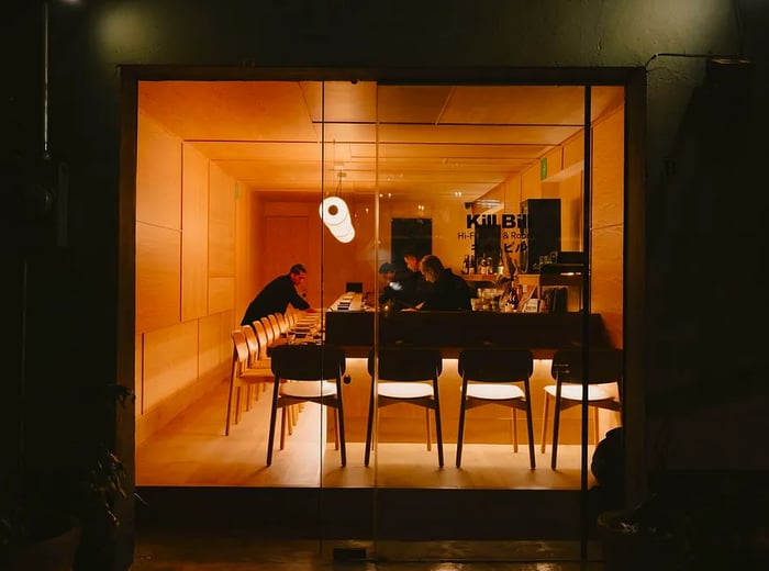 Staff prepares for service inside a sushi bar.