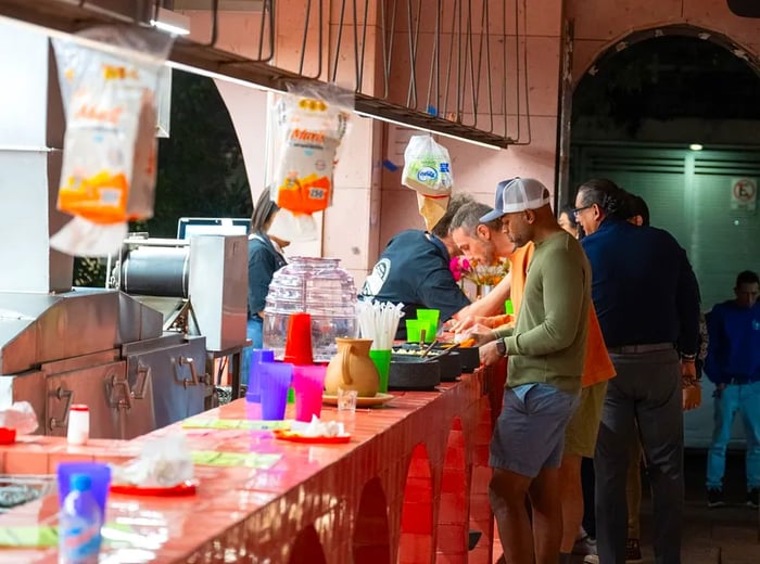 Customers gather at the taco counter.