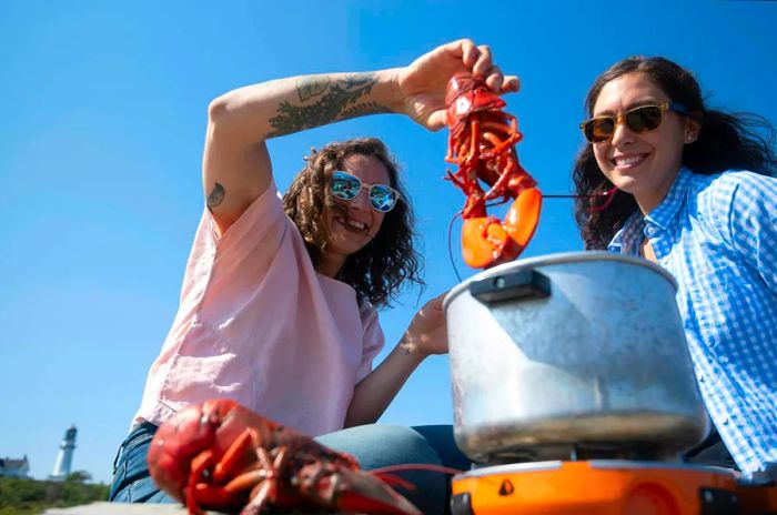 Boiling lobsters near Portland Head Light, Cape Elizabeth, Maine, USA