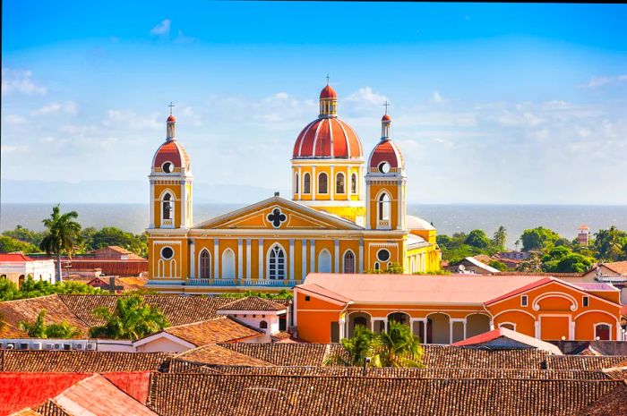 Aerial view of Granada, Nicaragua showcasing its colonial buildings with vibrant tiled roofs and the prominent yellow church