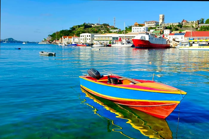 The vibrant port of St George's in Grenada with a colorful boat in the foreground