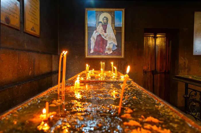 Candles and a religious icon displayed in Saint Sarkis Cathedral, Yerevan, Armenia