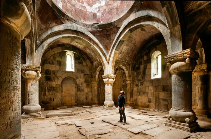 A visitor admires the vaulted ceiling of Sanahin Monastery, Armenia