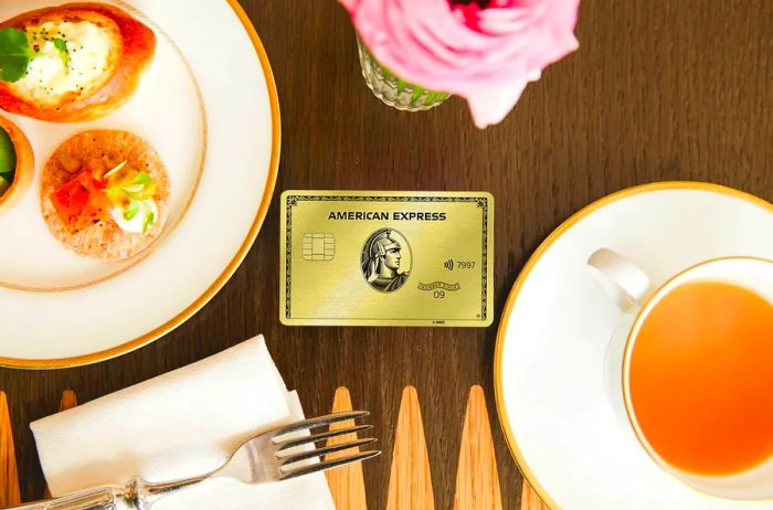 An image of the American Express Gold Card resting on a dining table