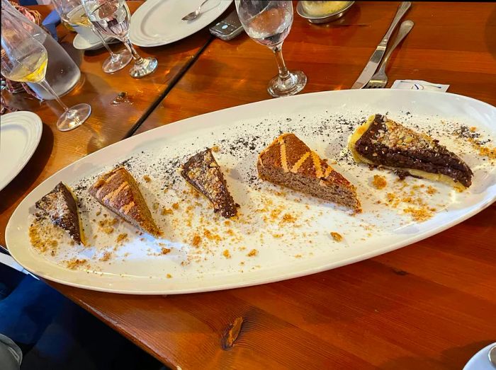 A plate adorned with slices of a nut-based tart