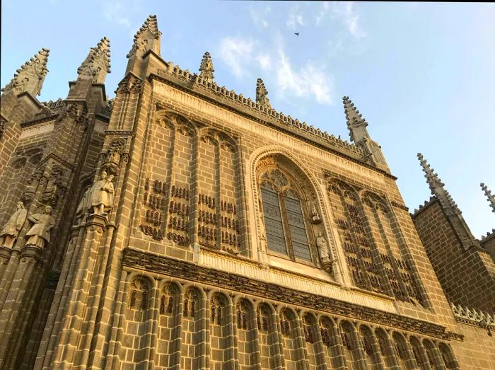 The Monastery of San Juan de los Reyes features a beautifully sculpted facade adorned with the coat of arms of the Catholic Monarchs.