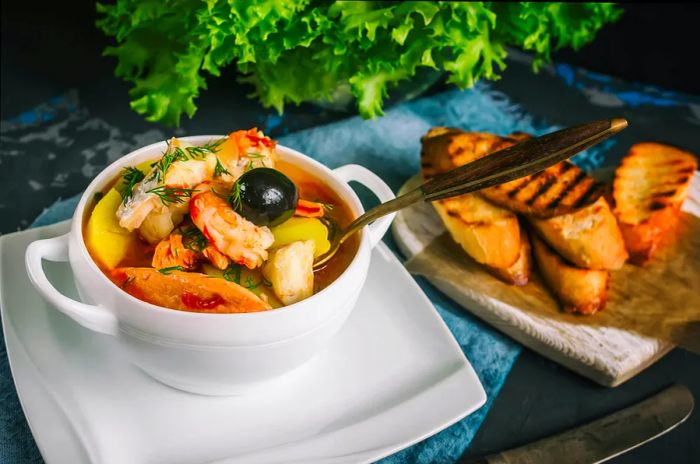 Delicious French fish soup Bouillabaisse featuring salmon fillet and shrimp.