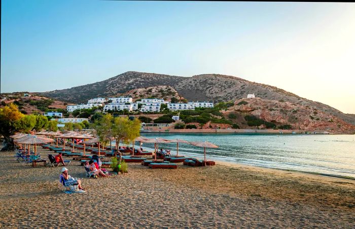 Swimmers bask in the sunset at the beach. Galissas is a charming village located about 5 km from Ermoupolis, the island’s capital in Syros.