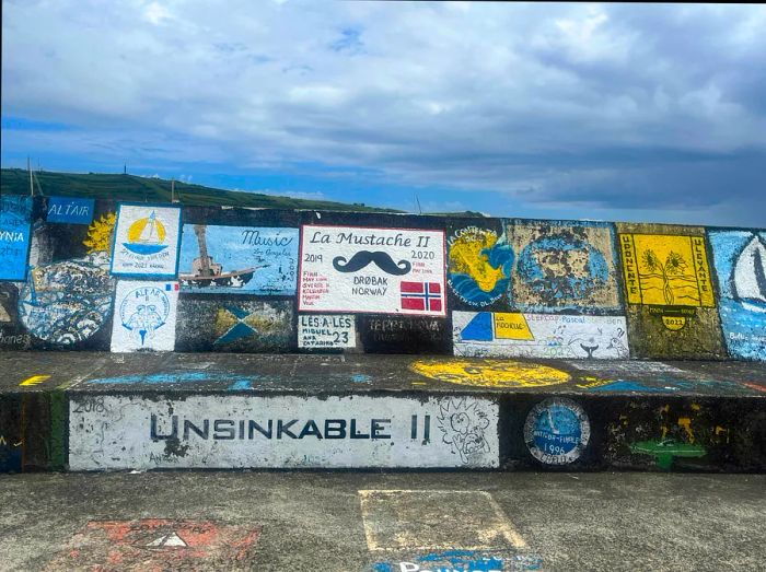 Vibrant murals adorn Faial harbor.