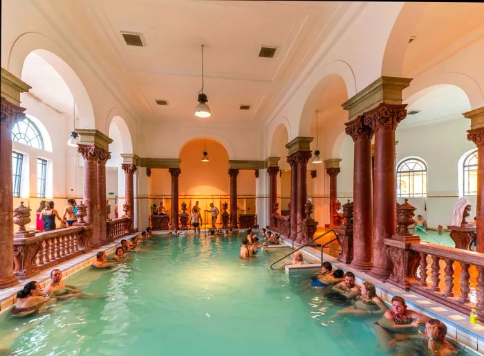 Visitors enjoy a soak in a spacious indoor thermal bath.