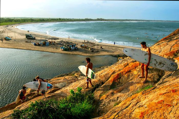 Young surfers heading to the beach in Sri Lanka.