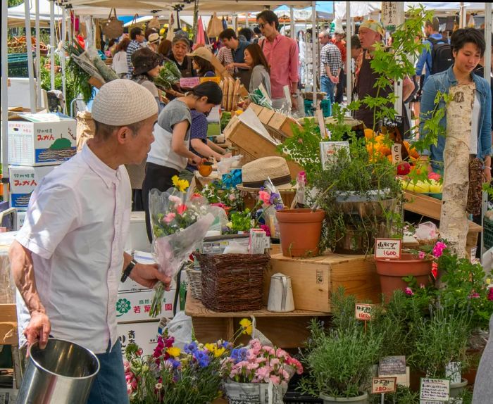 Man browsing a flower market in Tokyo, Japan.