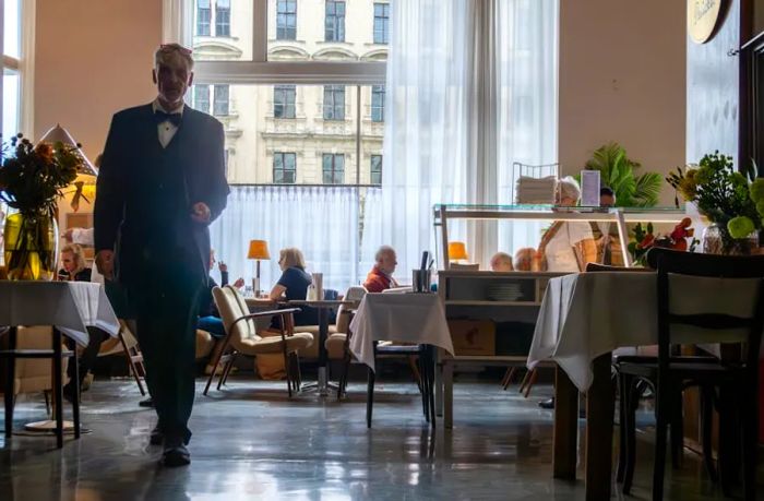 A waiter serving at the iconic café, Café Prückel, Vienna, Austria