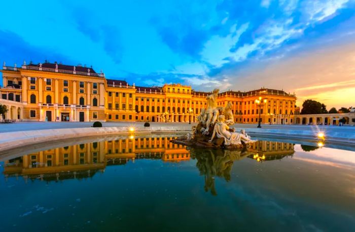 Sculptures at Schönbrunn Palace illuminated by sunset, Vienna, Austria