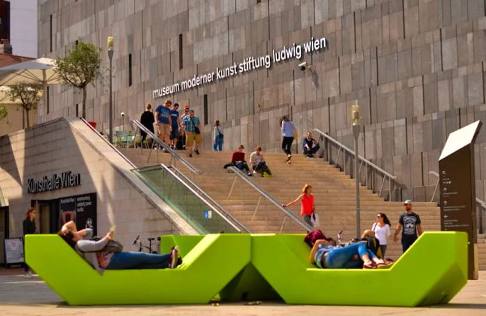 Visitors resting on benches outside MUMOK, MuseumsQuartier, Vienna, Austria