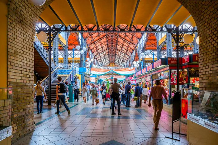 A bustling indoor marketplace filled with people