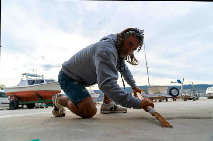 Roberto Vidal Pombo, a barnacle gatherer, sharpens his scraper blade before heading out.