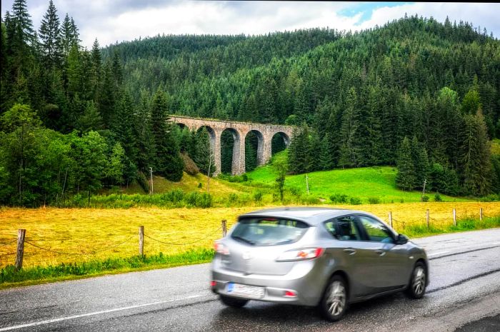 A vehicle drives past the Chmarošský Viaduct in Slovakia